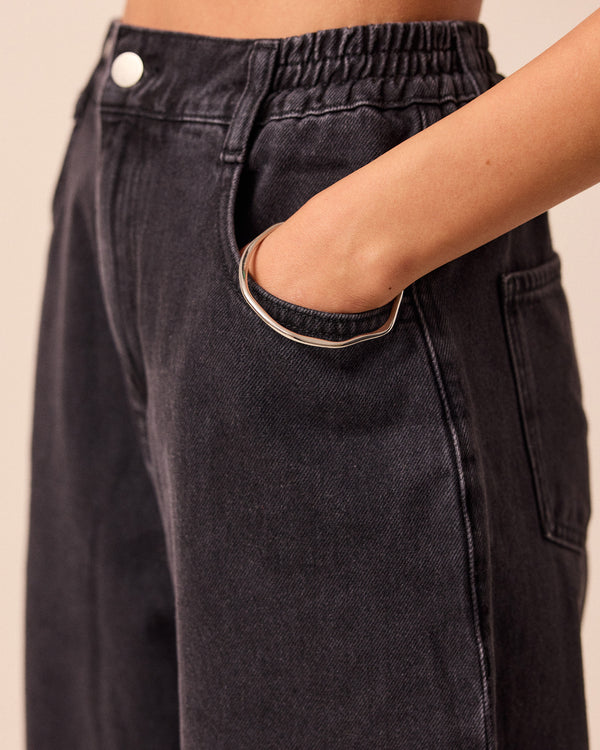 model wears remi washed black jeans front left