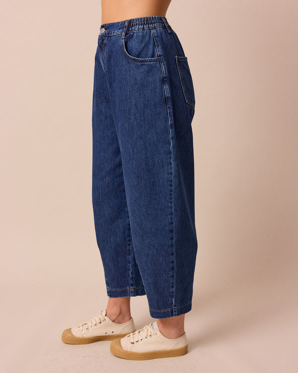 model wears remi mid wash denim jeans left