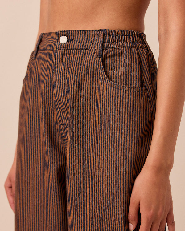 model wears remi hickory rust stripe jeans left