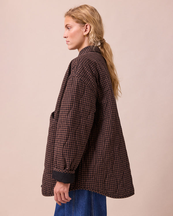model wears rue cocoa gingham denim jacket
