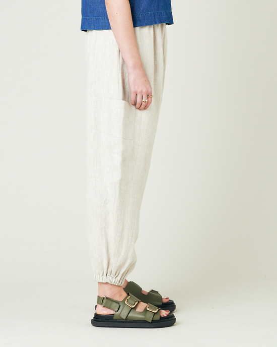 model wears natural linen yoli trousers right