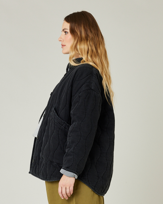 pregnant model wears washed black denim rue jacket