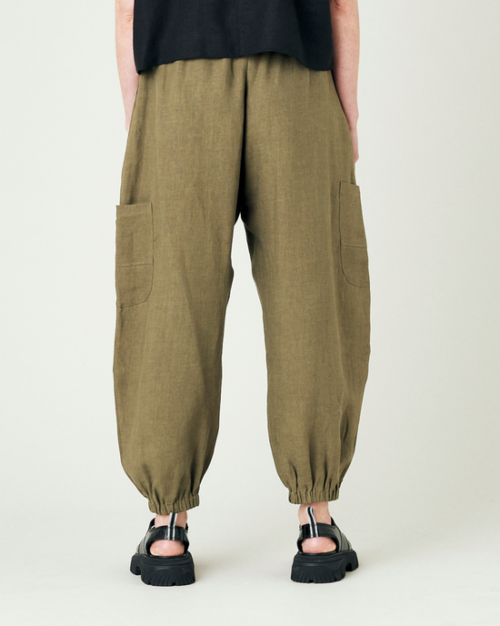 model wears light khaki linen yoli trousers back