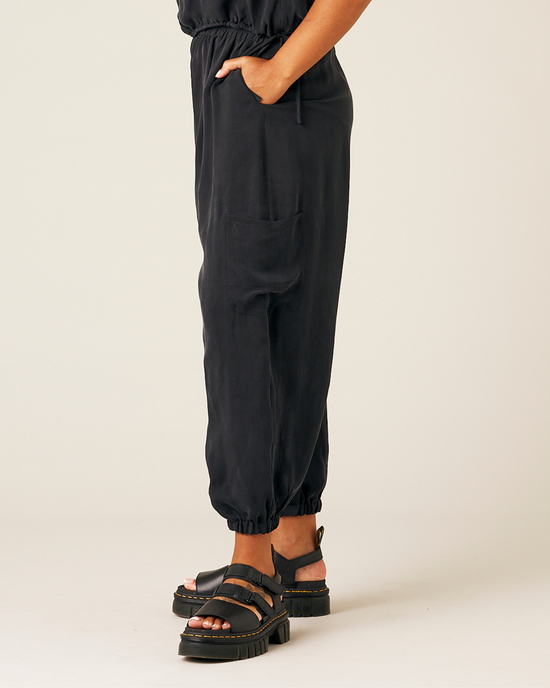 model wears black cupro yoli trousers left