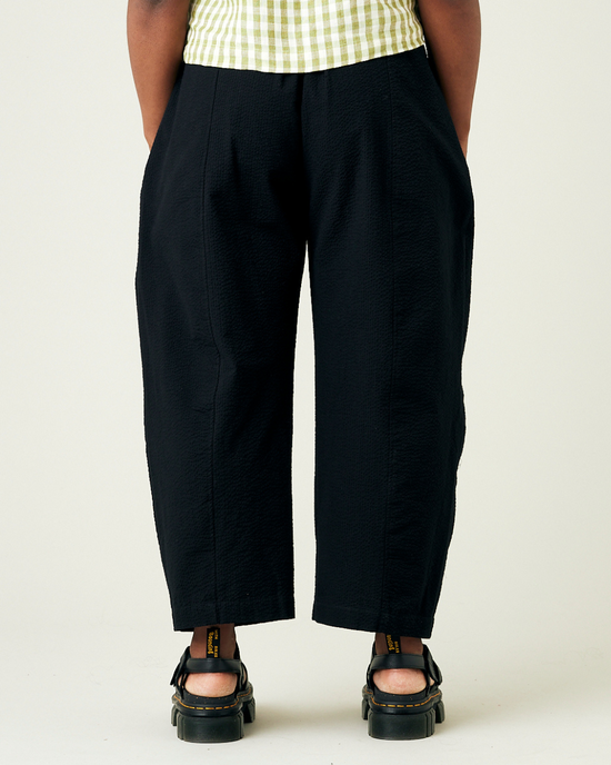 model wears black seersucker mabel trousers back