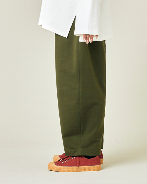 model wears olive jersey mabel trousers left