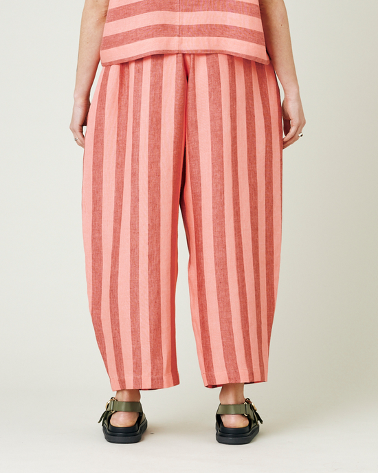 model wears blush stripe mabel trousers from the back