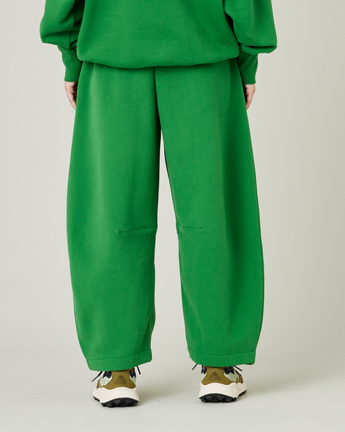 model wears juniper green daisy jersey trousers back