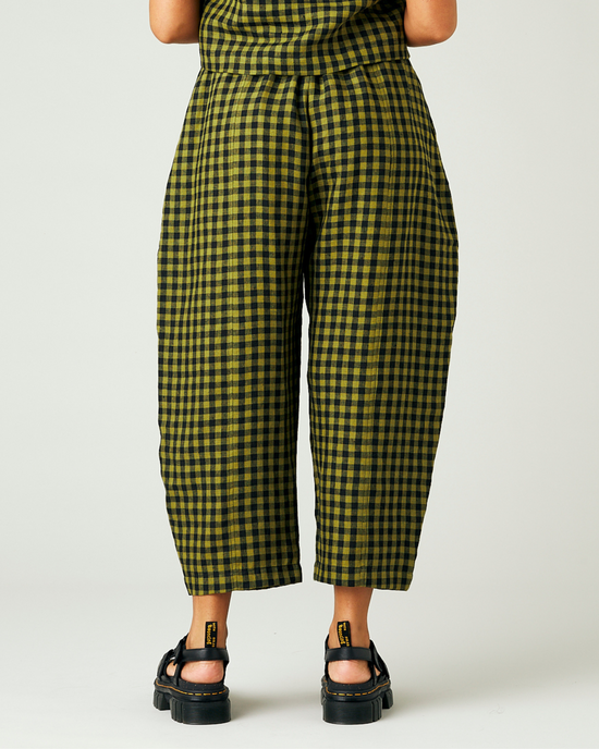 model wears green gingham linen mabel trousers from the back