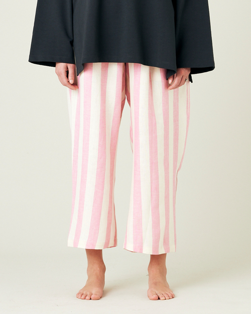 model wears pink and ecru stripe ultimate pj linen trousers