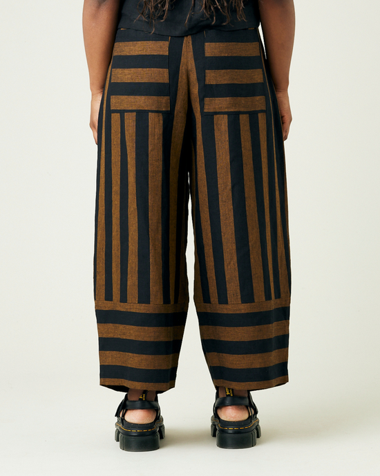 model wears rust stripe bobbi trousers back