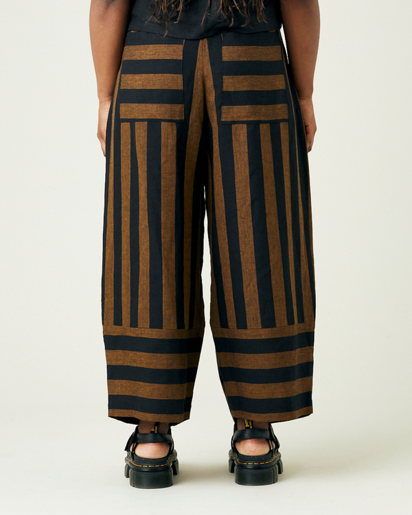 model wears rust stripe bobbi trousers 