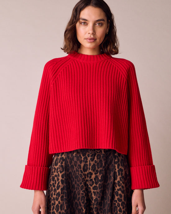 model wears cadi cherry red knitted jumper