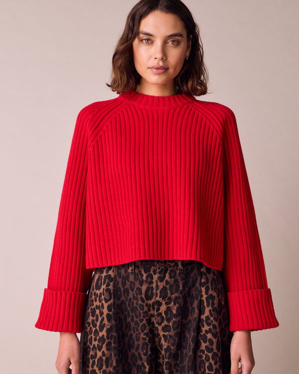 model wears cadi cherry red knitted jumper