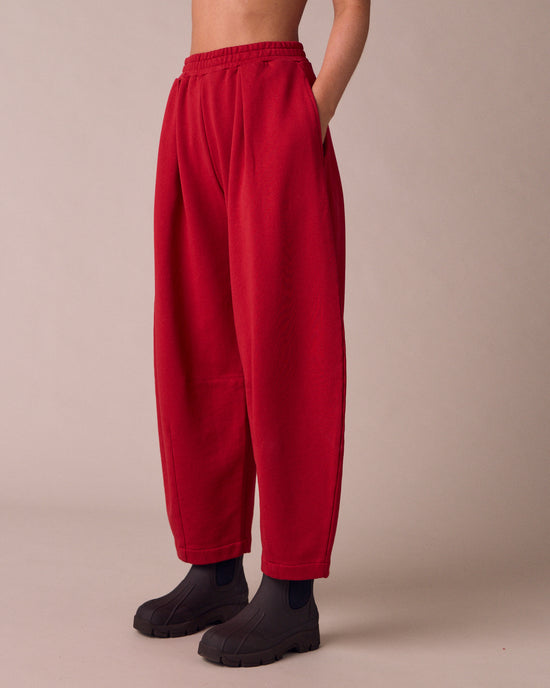 model wears daisy cherry red fleeceback jersey trousers left
