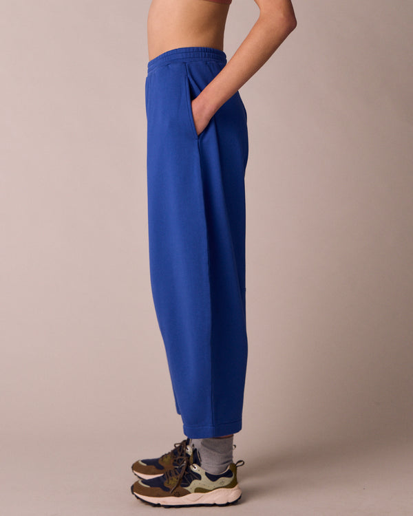 model wears daisy cobalt jersey fleeceback trousers left