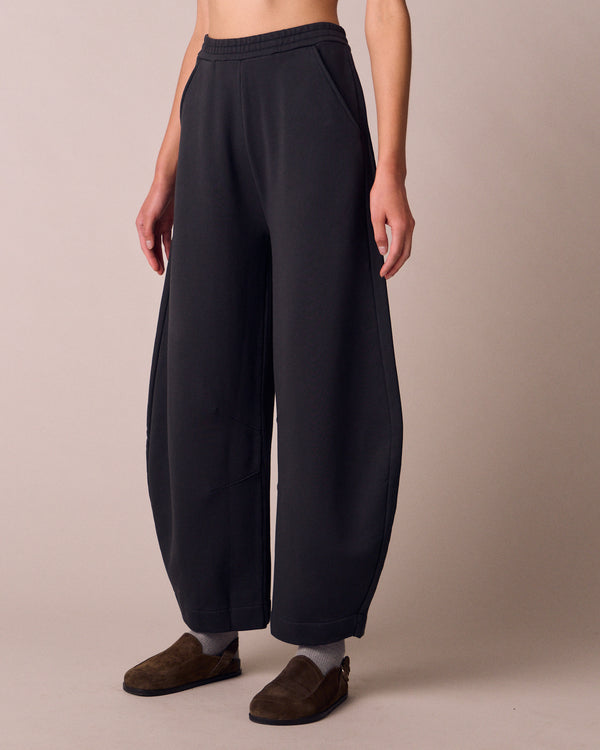 model wears helina washed black jersey trousers left