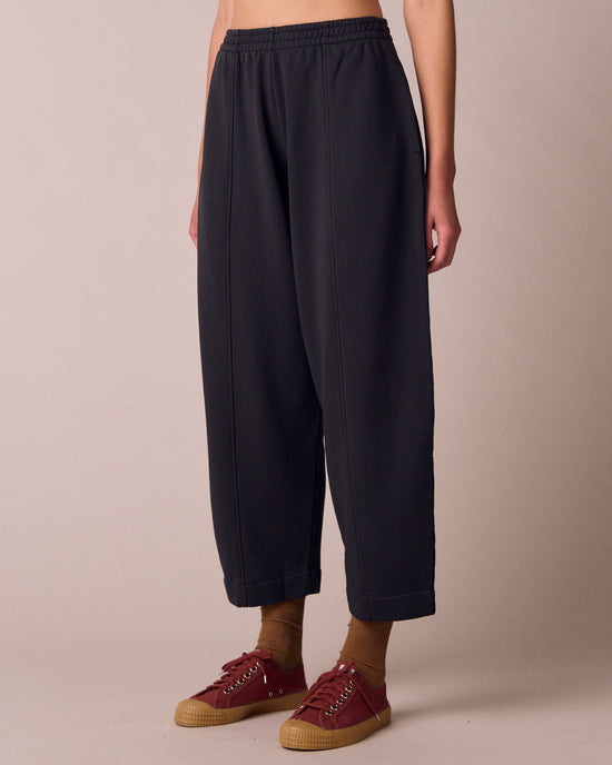 model wears mabel washed black fleeceback jersey trousers left