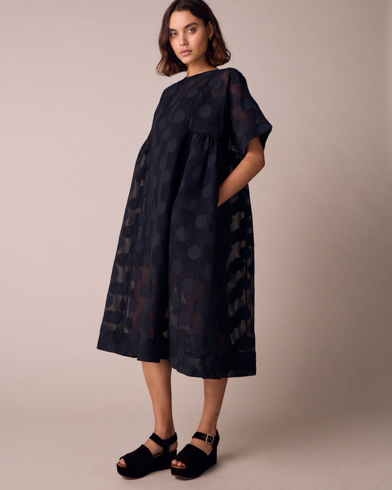 model wears zyla black sheer spot dress