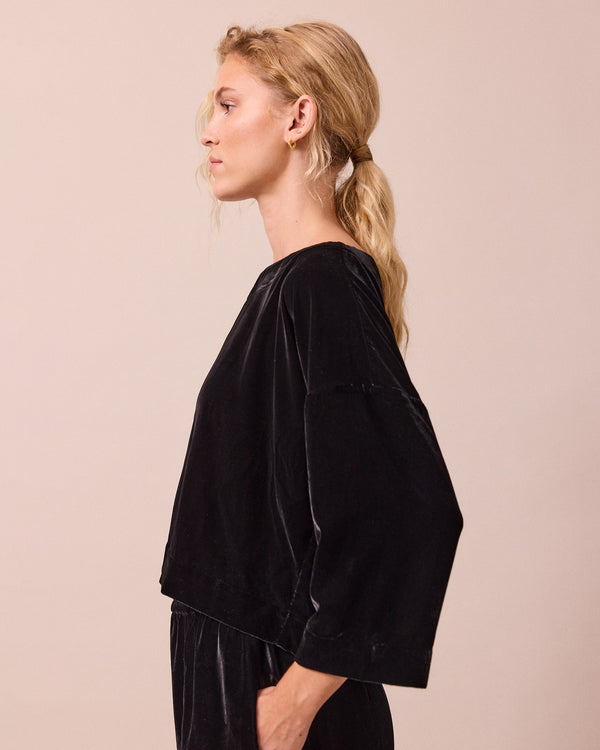 model wears lily black velvet top