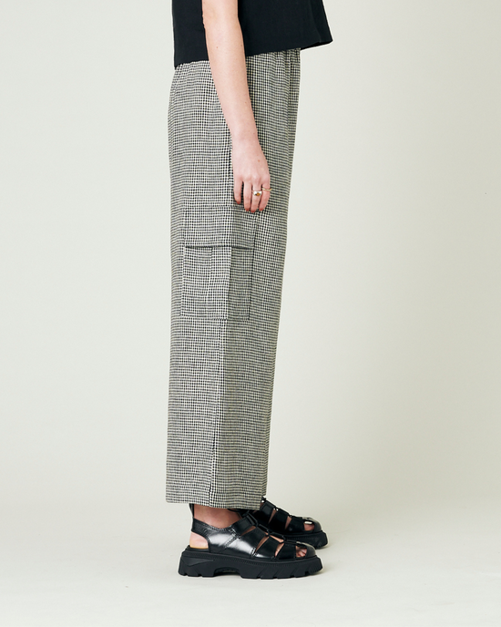 model wears black and stone micro gingham orla trousers right