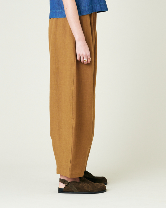 model wears bronze daisy linen trousers right