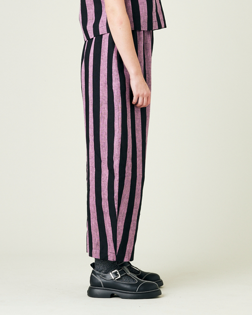 model wears pink and black stripe linen mabel trousers from the right