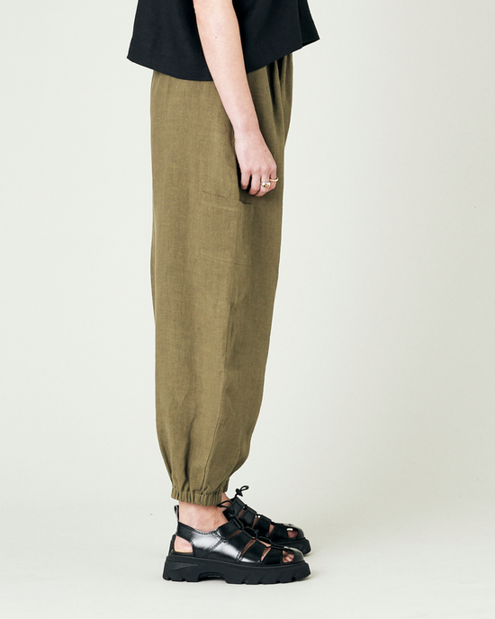 model wears light khaki linen yoli trousers right