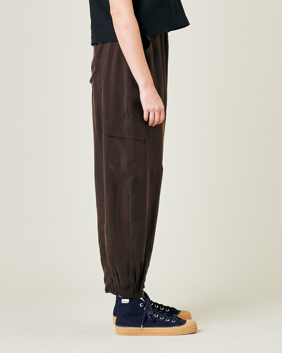 model wears espresso cupro sylvie trousers right