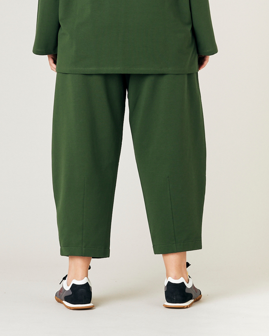 model wears kombu green jersey huxley trousers back