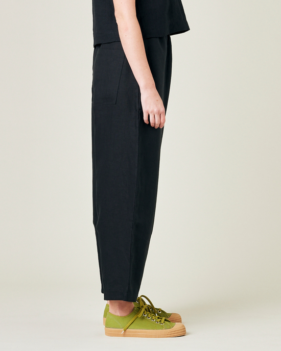 model wears black linen huxley trousers 