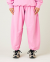 model wears pink daisy jersey trousers front