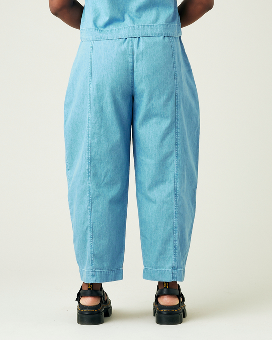 model wears light wash chambray mabel trousers back