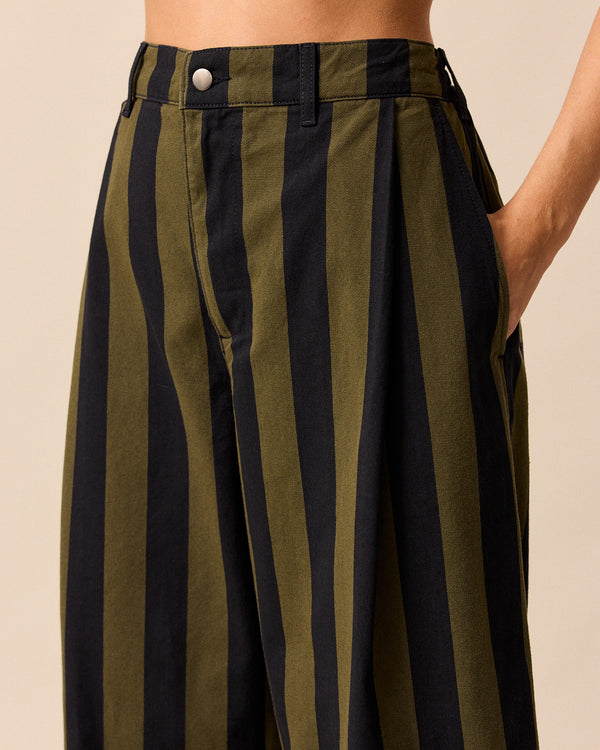 model wears blair olive and black stripe denim trousers right