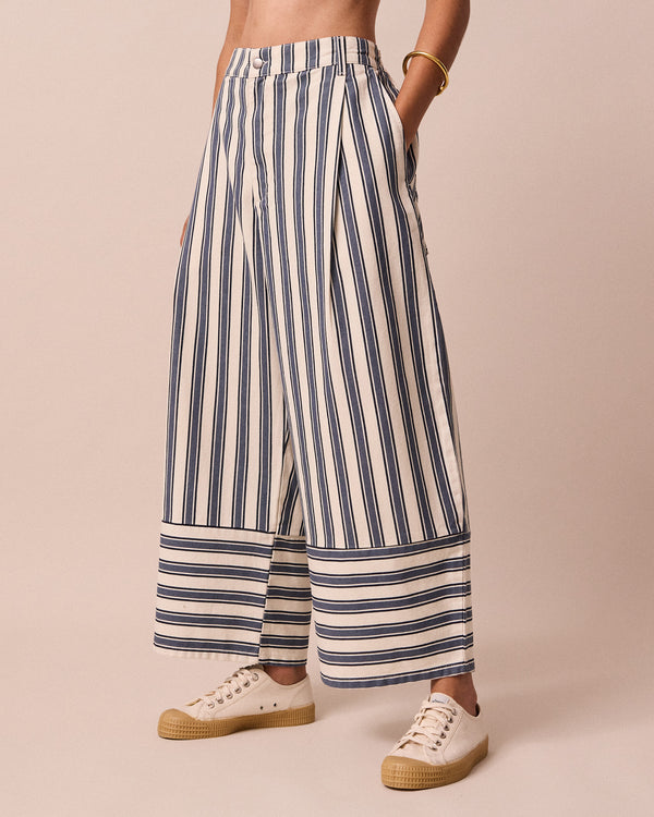 model wears blair sailor stripe denim jeans left