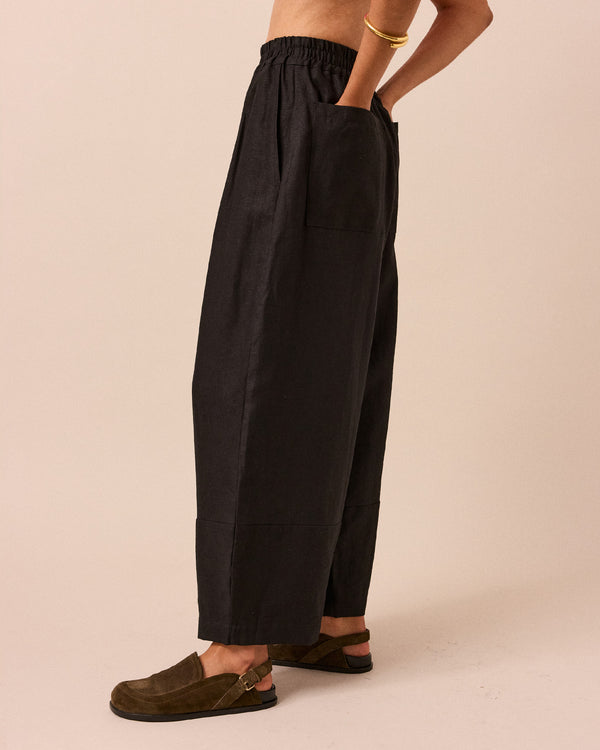 model wears black bobbi linen trousers left