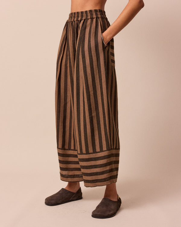 model wears walnut stripe bobbi linen trousers left