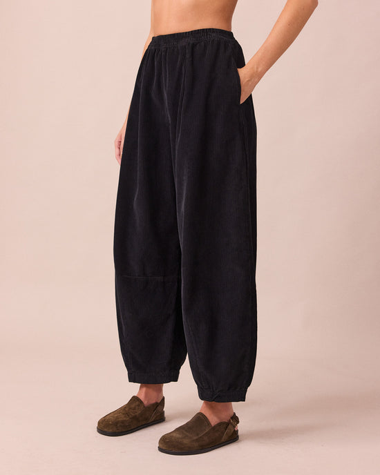 model wears daisy black cord trousers