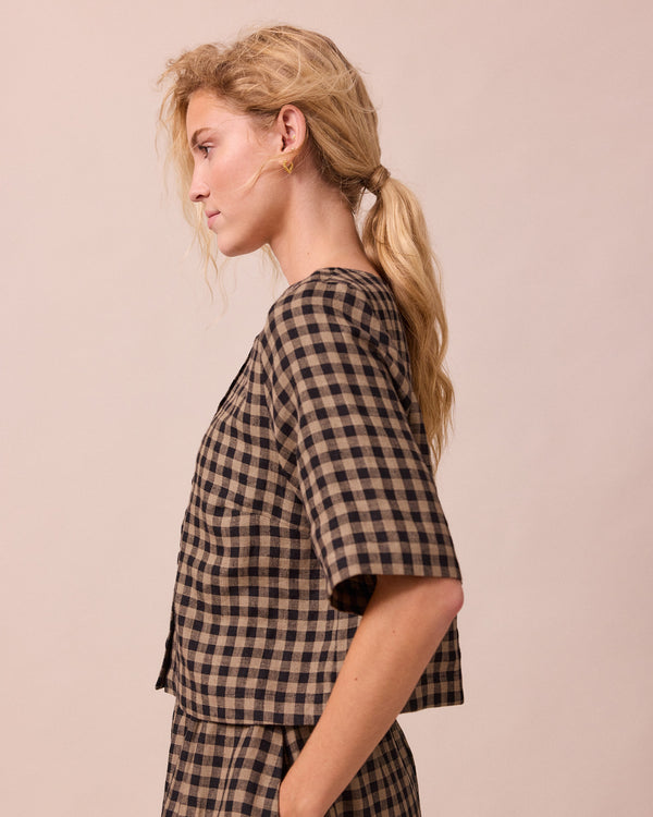 model wears evelyn coffee gingham linen top left