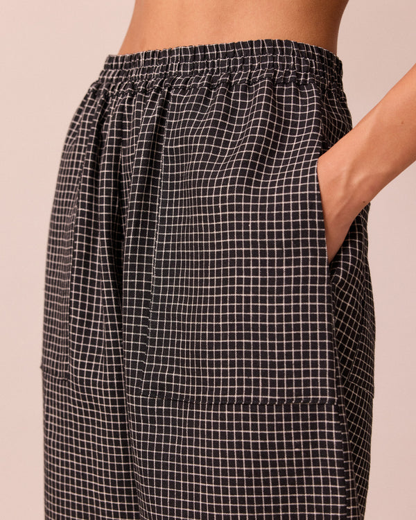 model wears huxley black mini grid linen trousers