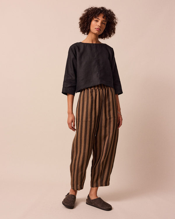 model wears walnut stripe huxley linen trousers right