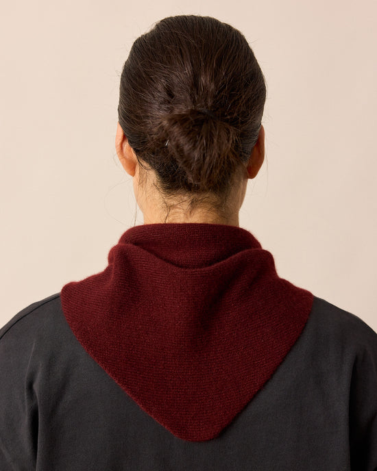 model wears dark burgundy knitted neckerchief