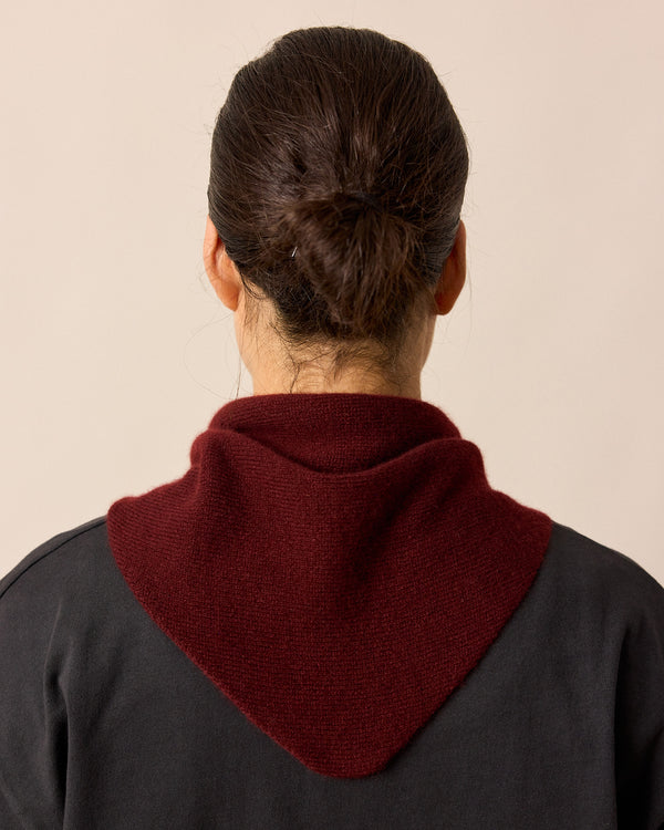 model wears dark burgundy knitted neckerchief
