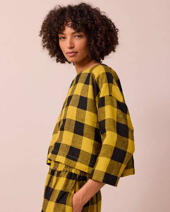 model wears lily chartreuse check linen top