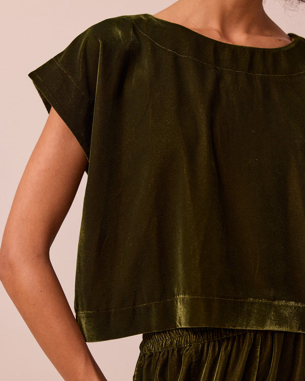 model wears polly moss green velvet top