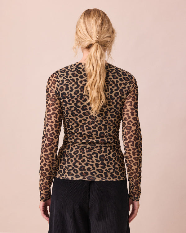model wears mesh leopard print long sleeved top