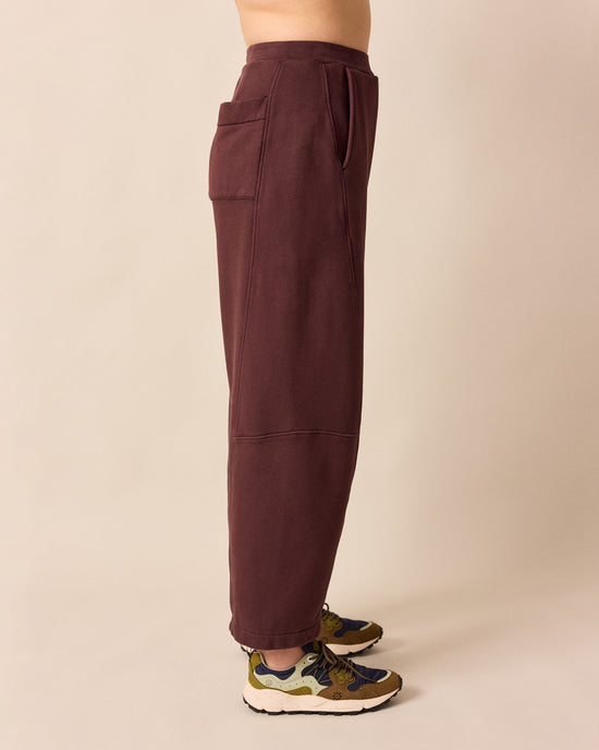 model wears lyra burgundy fleeceback jersey trousers right