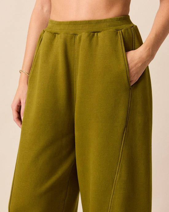 model wears lyra fresh olive jersey trousers