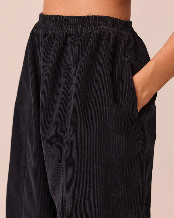 model wears mabel black cord trousers