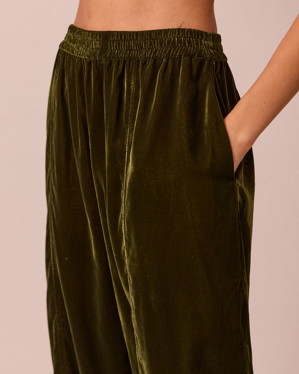 model wears mabel moss green velvet trousers